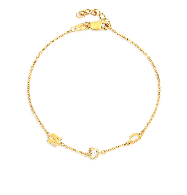 Gold chain bracelet with diamond heart charm and letter 'M' charm and 'D' charm 